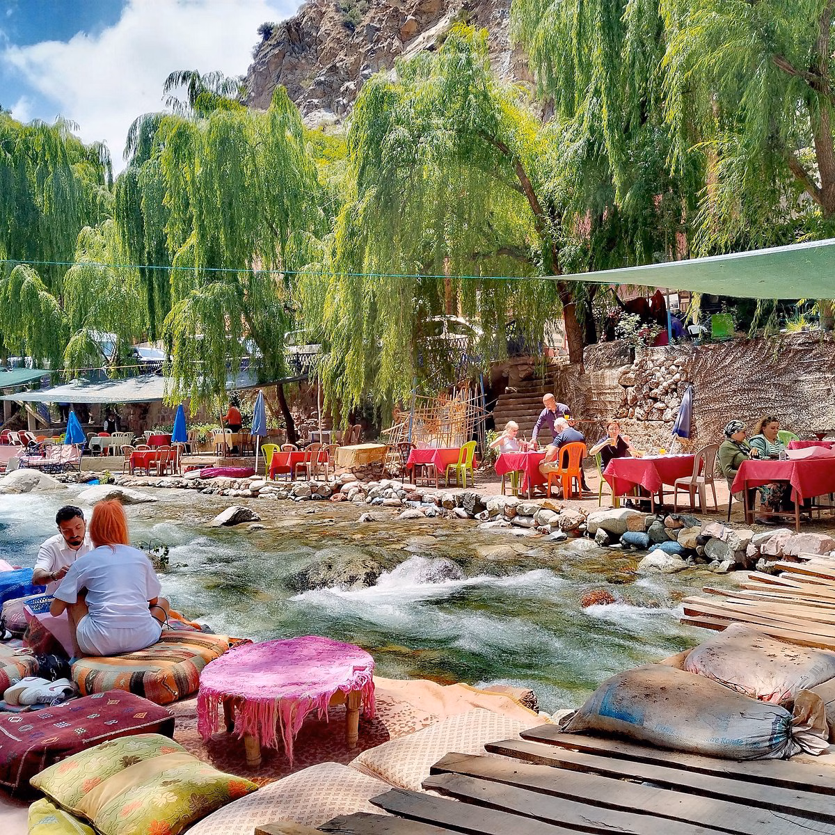 Ourika Valley excursion private tour couple dining at restaurant tables in river Setti Fatma English guide Zagora Experience